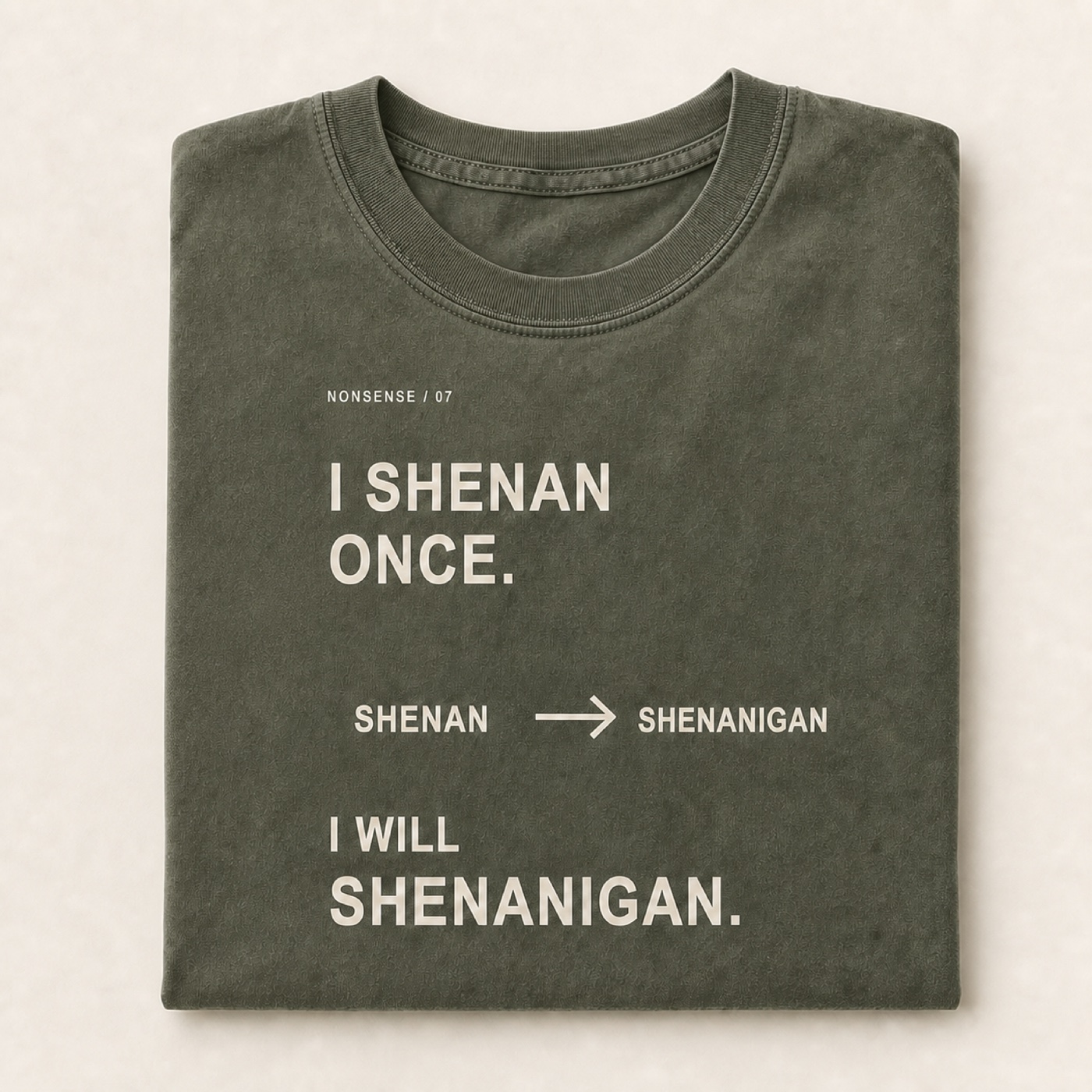 Shenanigan printed on a folded Moss heavyweight T-shirt.