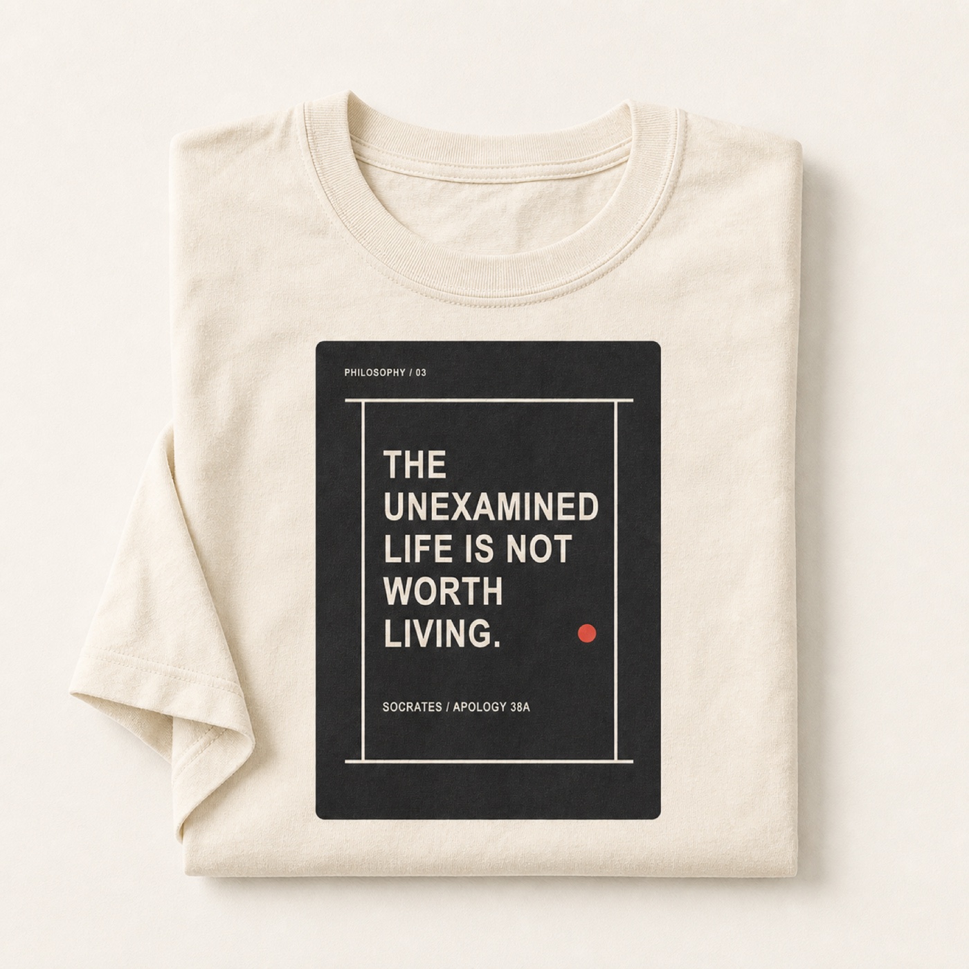 The Examined Life printed on a folded Ivory heavyweight T-shirt.