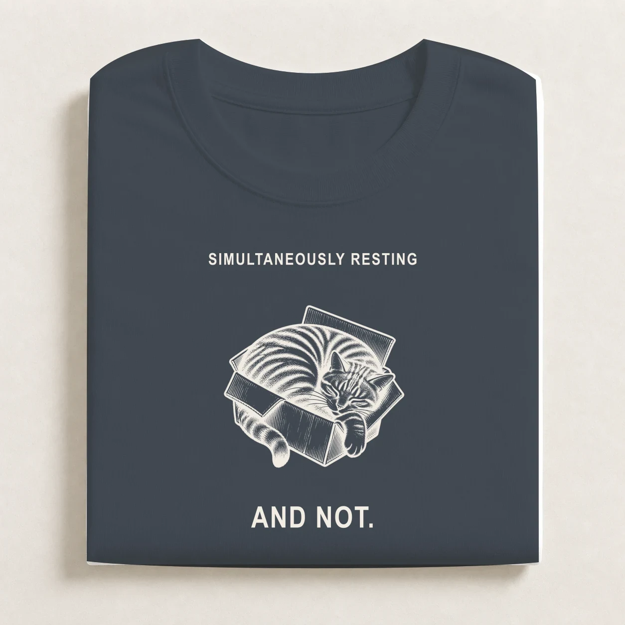 Folded Petrol Blue shirt with the Schrodinger's Nap print.