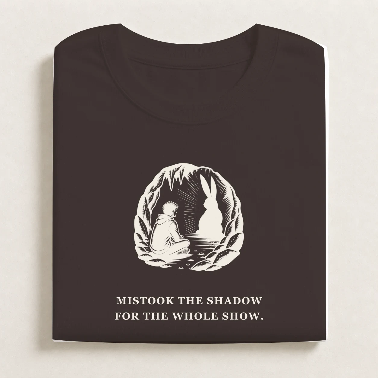 Plato's Cave printed on a folded Coal T-shirt.