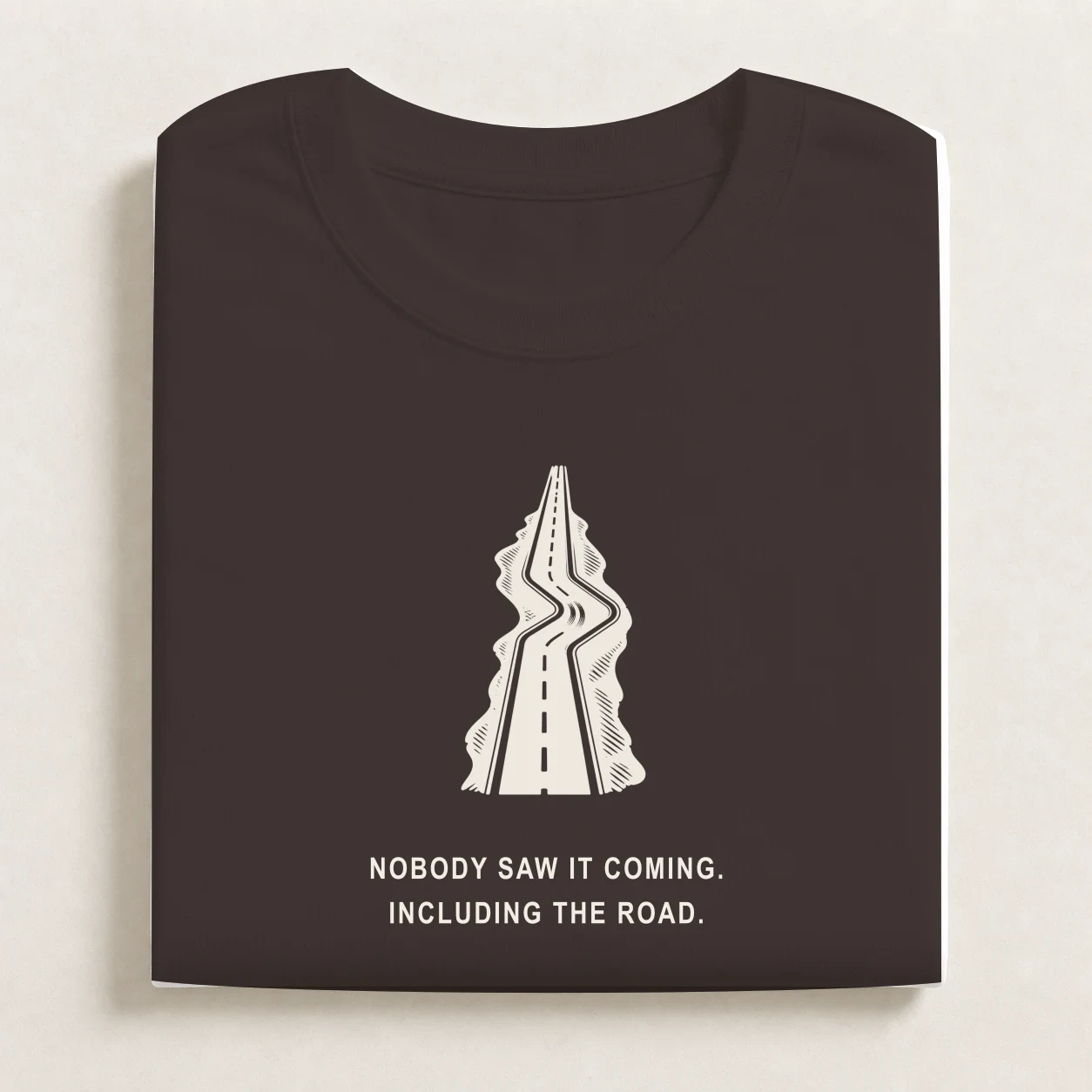 Plot Twist printed on a folded Coal T-shirt.