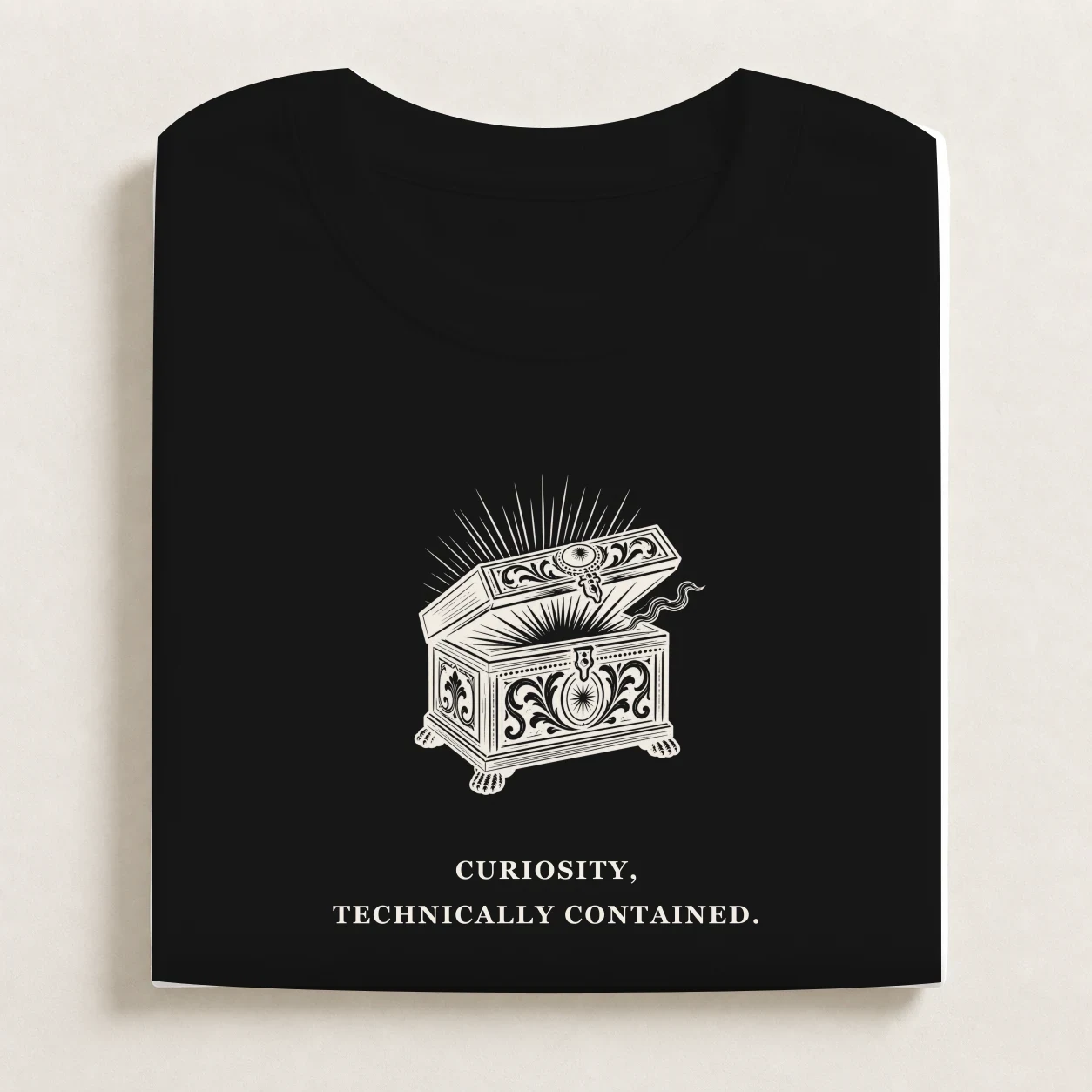 Pandora's Box printed on a folded Black T-shirt.